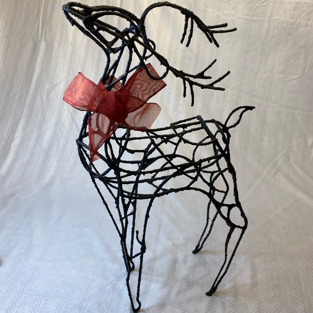 Wired reindeer with red ribbon. Christmas decor.
